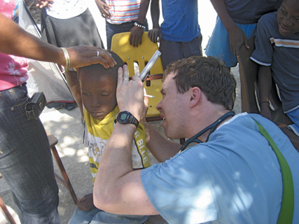 Casey M McMillan ACP Member examines a patient after the Haitian earthquake Photo courtesy of Dr McMillan