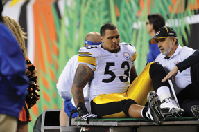 Anthony Yates MD FACP rides a cart off the playing field while treating an ankle injury to Maurkice Pouncey a center with the Pittsburgh Steelers Photo by SteelersslashMike Fabus